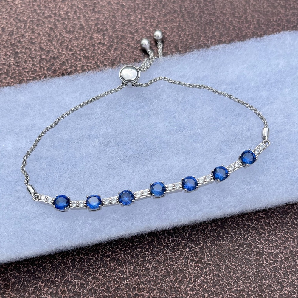 Zales Lab-Created Blue Sapphire and Diamond Bolo Bracelet in Sterling Silver.